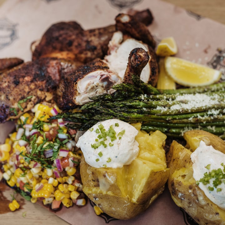 BBQ whole chicken with baked potato, asparagus & corn salsa